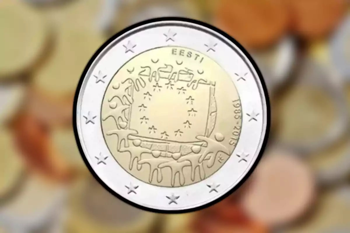Moneda commemorativa d’Estònia amb disseny artístic i estrelles a la vora sobre un fons desenfocat d’altres monedes Moneda commemorativa d’Estònia amb disseny artístic i estrelles a la vora sobre un fons desenfocat d’altres monedes