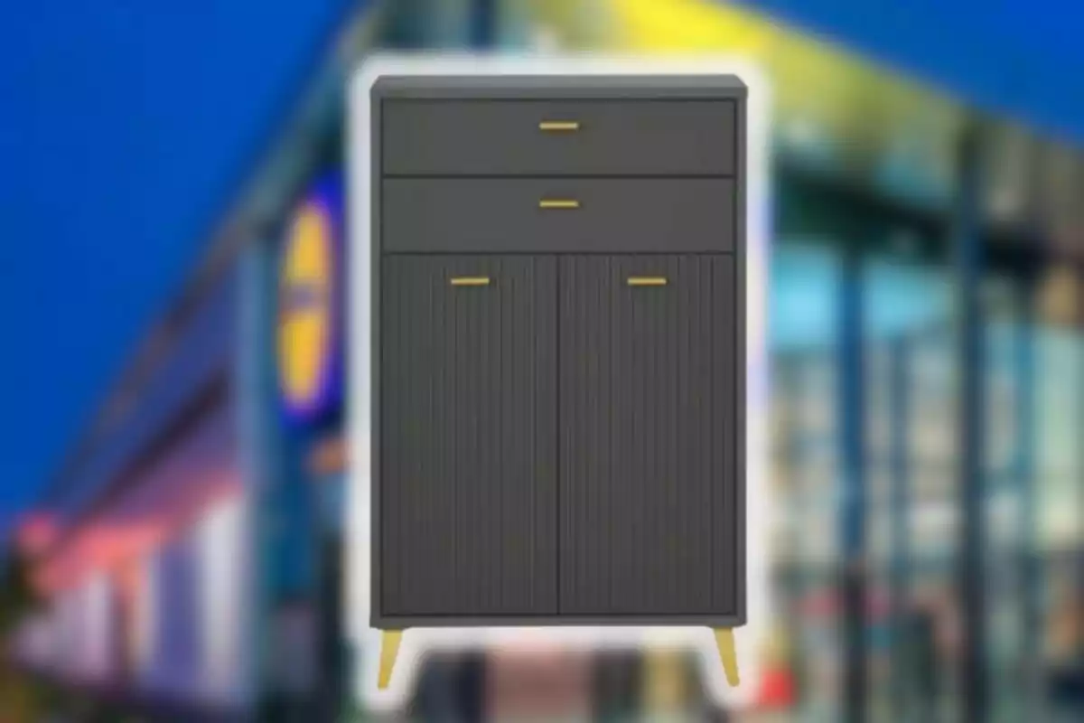 Moble negre amb potes i tiradors daurats davant d’un fons desenfocat d’una botiga