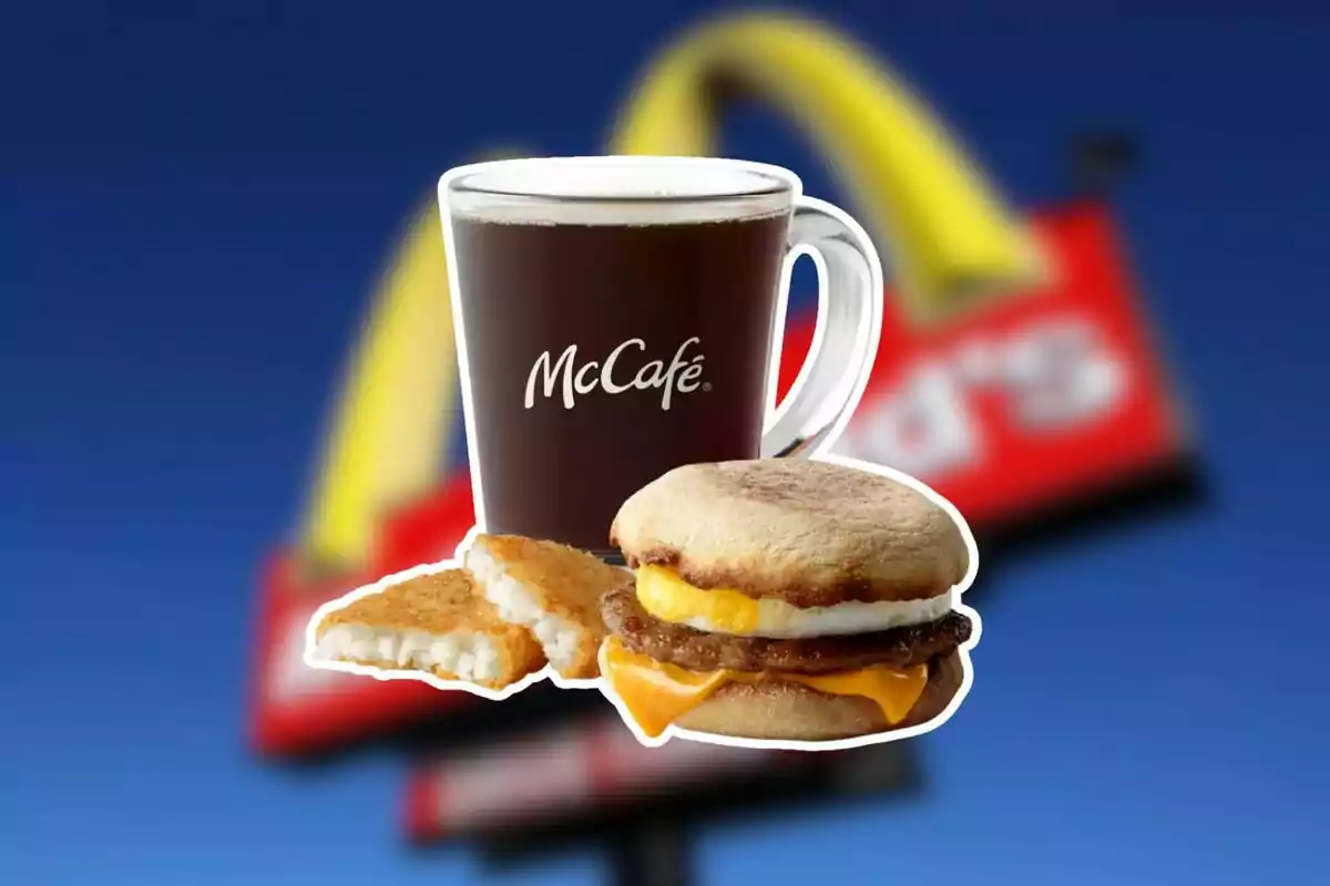 McCafé coffee cup next to a hash brown and a breakfast sandwich with egg, cheese, and sausage in front of a blurry McDonald's sign