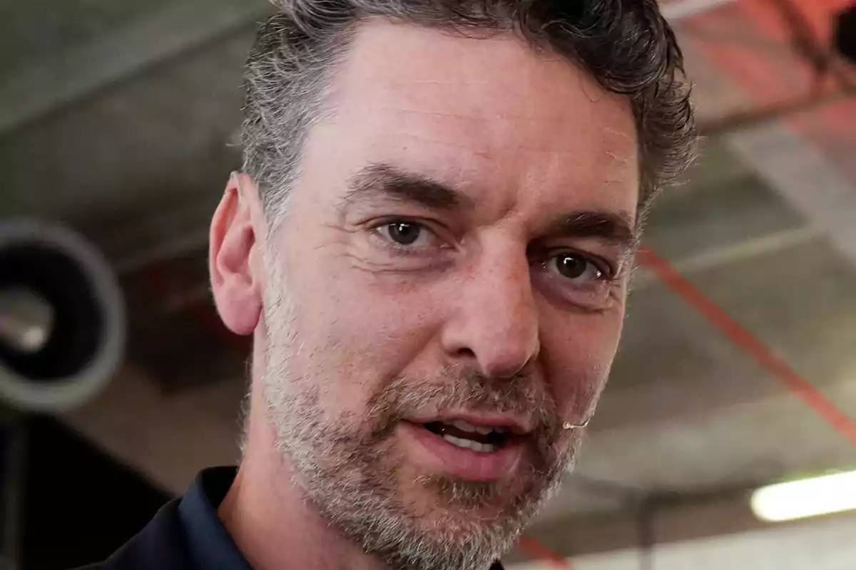 Primer pla de Pau Gasol amb expressió seriosa en un entorn interior industrial
