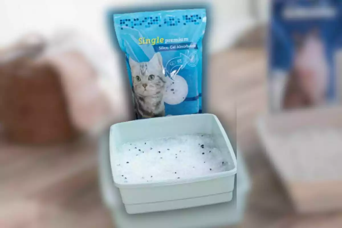 Un paquet de sorra per a gats de gel de sílice al costat d'una safata plena del mateix material. Un paquet de sorra per a gats de gel de sílice al costat d'una safata plena del mateix material.