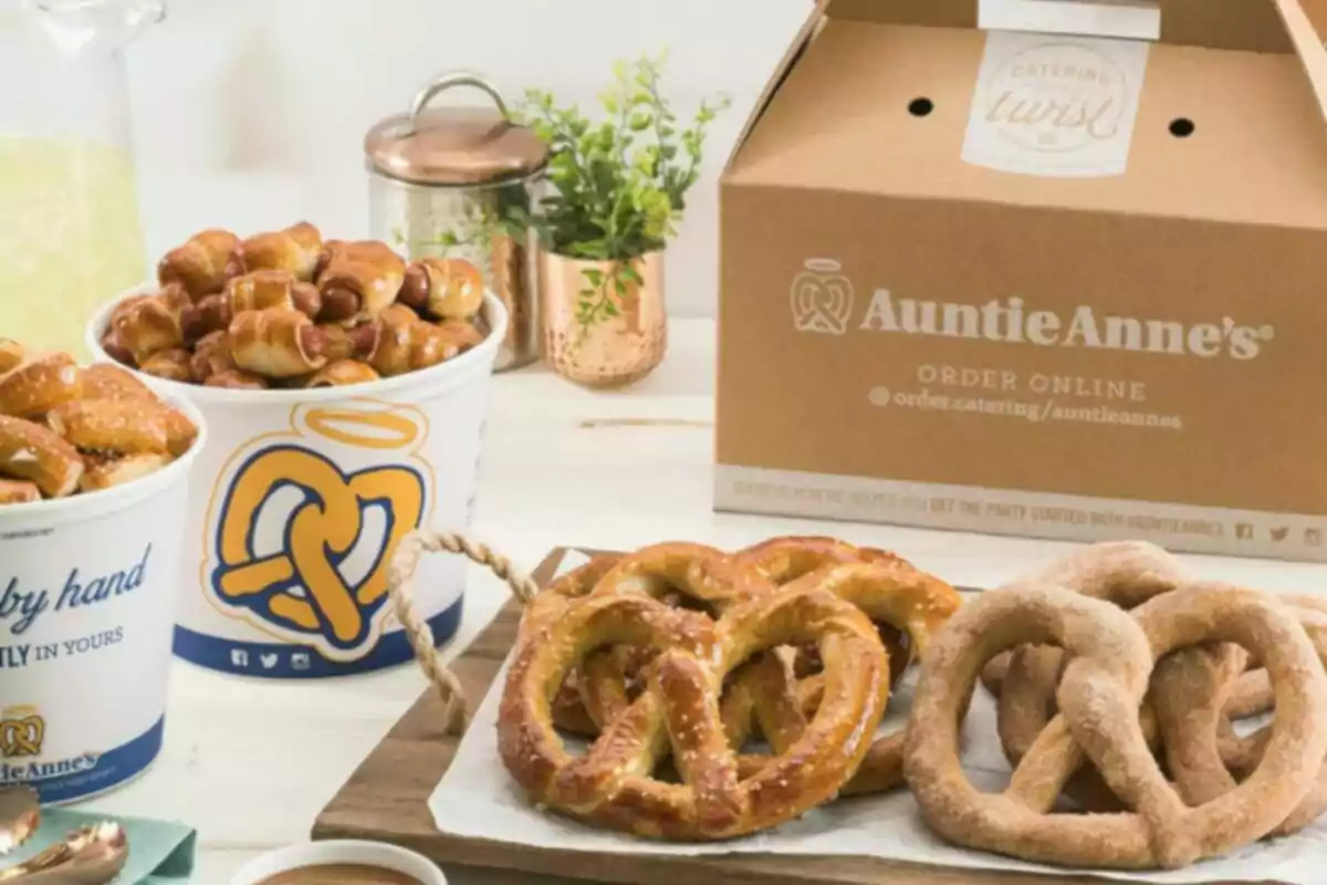 Auntie Anne's pretzels and pretzel snacks served on a table next to a cardboard box and drinks Auntie Anne's pretzels and pretzel snacks served on a table next to a cardboard box and drinks