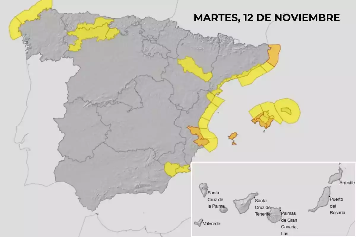 Mapa de España con alertas meteorológicas en amarillo y naranja para el martes 12 de noviembre mostrando áreas afectadas en la península y las Islas Canarias.