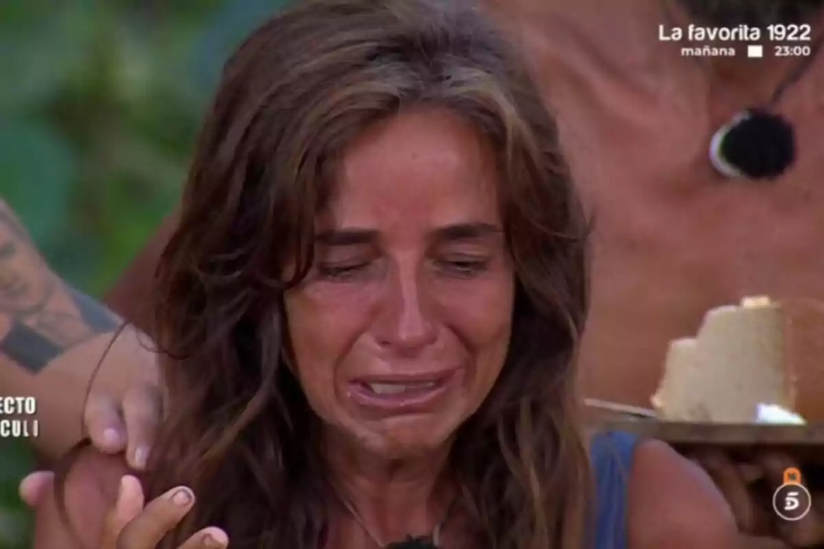 Carmen Alcayde llorando mientras alguien la consuela en un entorno al aire libre en Supervivientes. Carmen Alcayde llorando mientras alguien la consuela en un entorno al aire libre en Supervivientes.