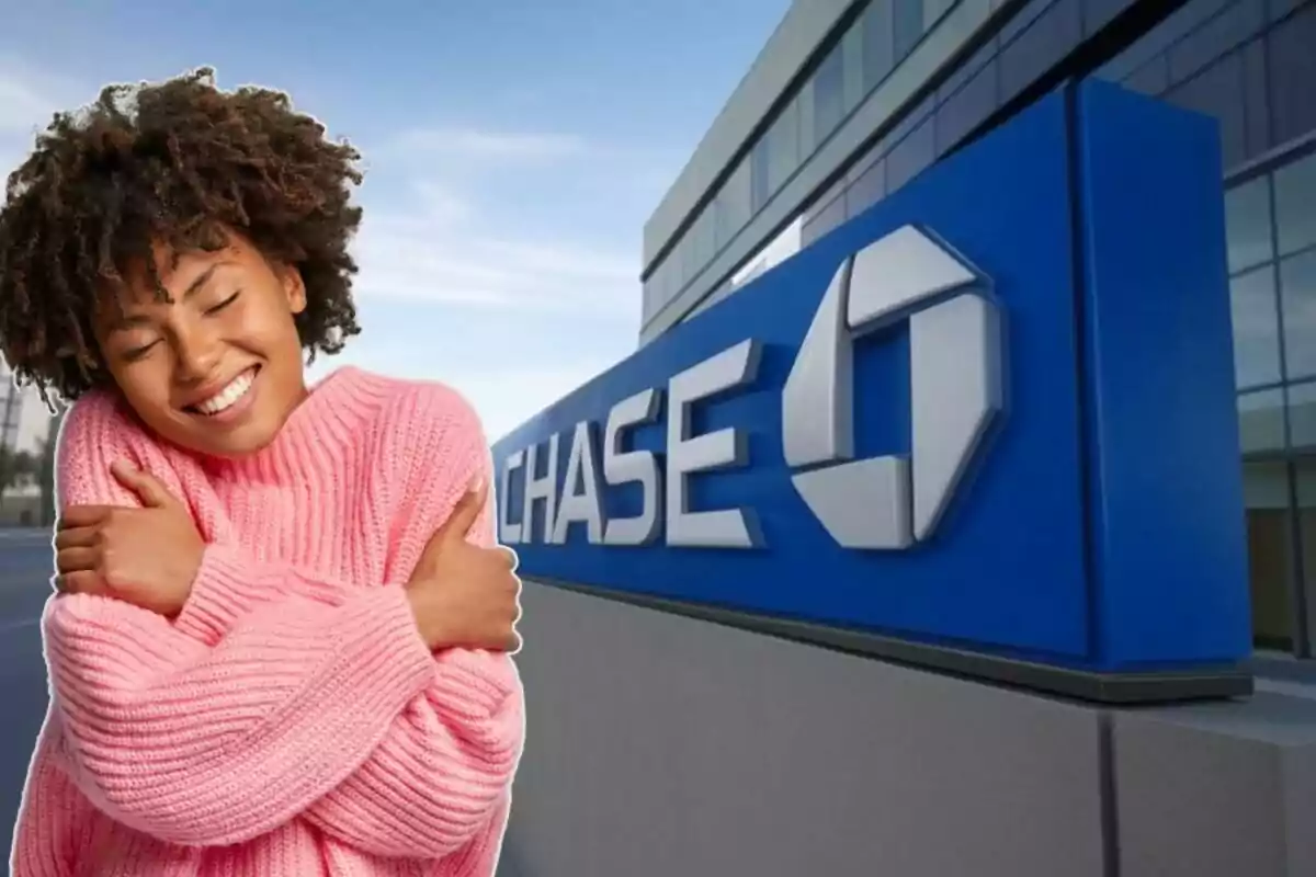 A person in a pink sweater smiles and hugs herself in front of a building with the Chase logo. A person in a pink sweater smiles and hugs herself in front of a building with the Chase logo.