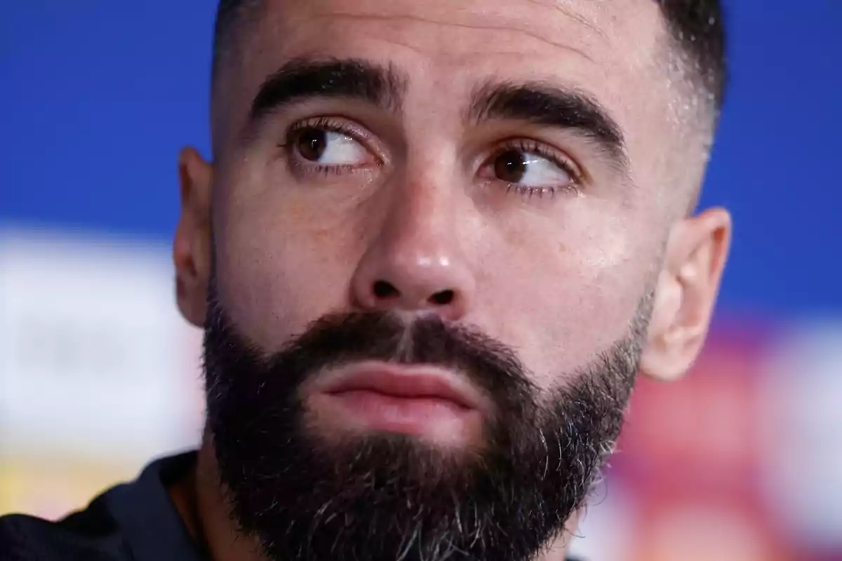 Close-up of a man with a beard and short hair looking to the side. Close-up of a man with a beard and short hair looking to the side.