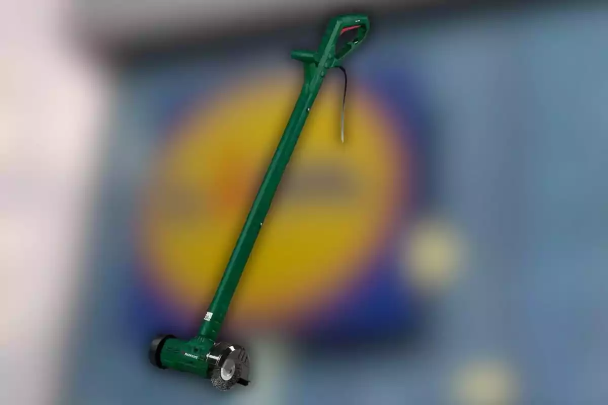Una eina verda amb mànec llarg i raspall a la base sobre un fons desenfocat. Una eina verda amb mànec llarg i raspall a la base sobre un fons desenfocat.