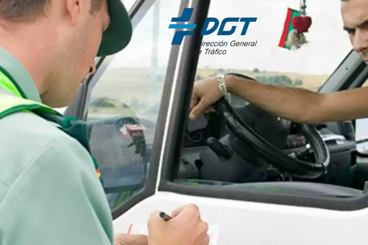 Un agent de la Direcció General de Trànsit (DGT) revisa documents mentre un conductor espera al vehicle.