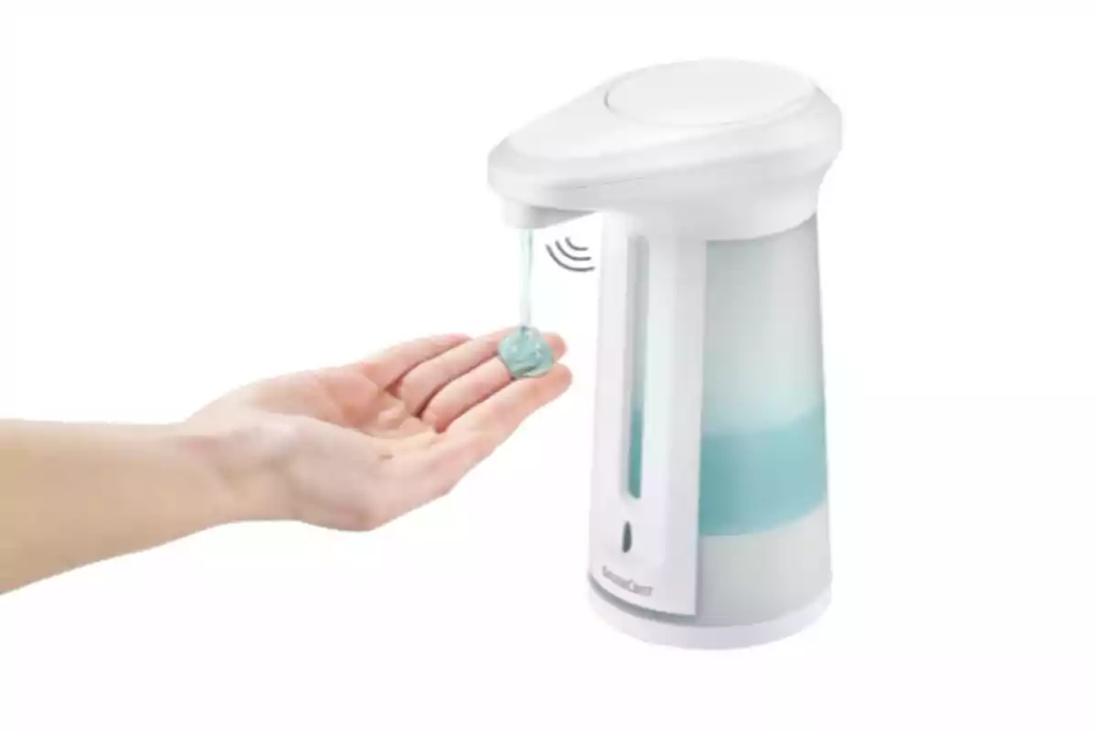 Una mà rebent sabó líquid d’un dispensador automàtic blanc amb sensor Una mà rebent sabó líquid d’un dispensador automàtic blanc amb sensor