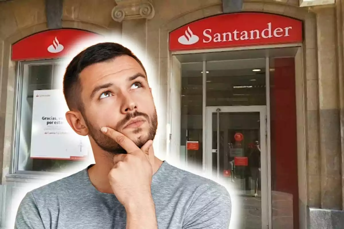 Un home pensatiu davant d'una sucursal del banc Santander.