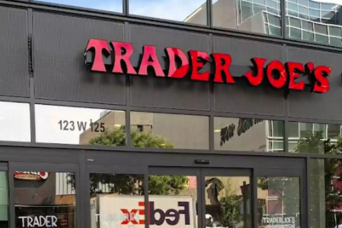 Facade of a Trader Joe's store with a red sign and glass windows. Facade of a Trader Joe's store with a red sign and glass windows.