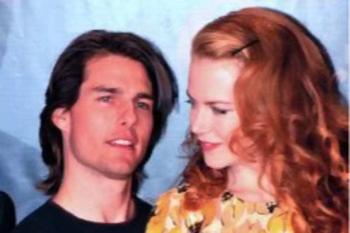 Tom Cruise and Nicole Kidman posing together in front of a blue background. Tom Cruise and Nicole Kidman posing together in front of a blue background.