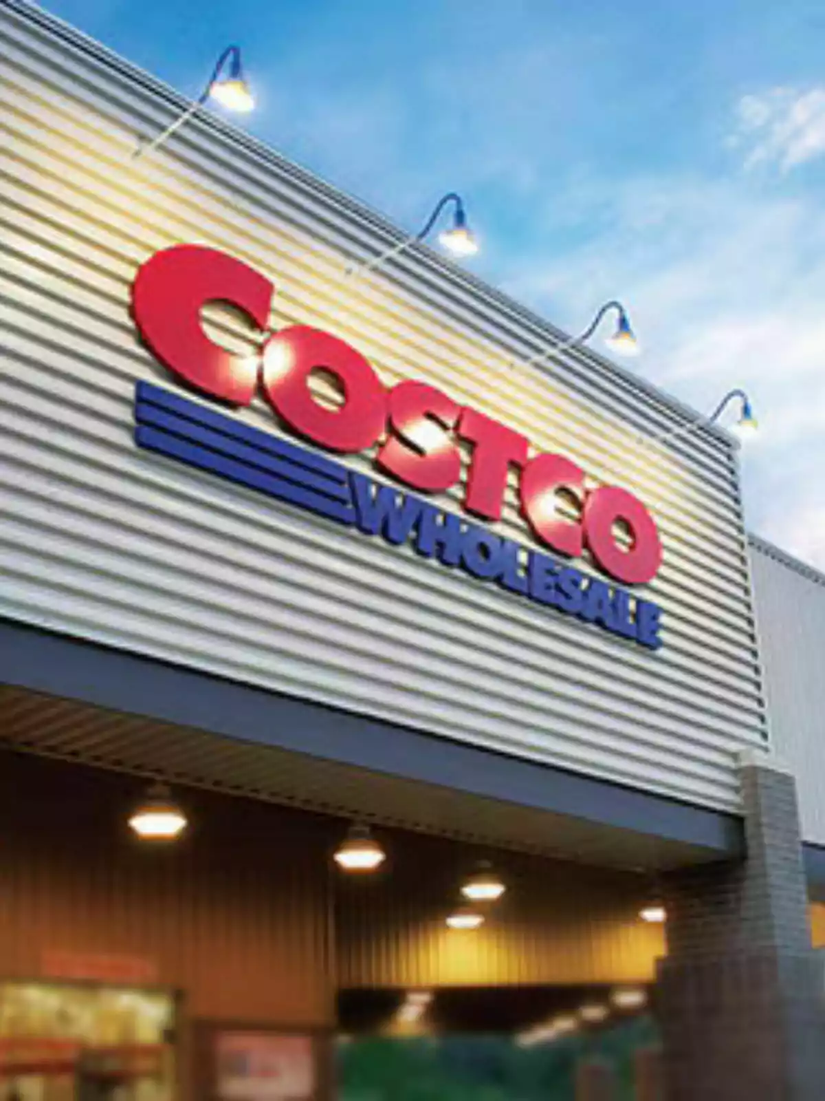 Storefront with a large, colorful sign under a blue sky.