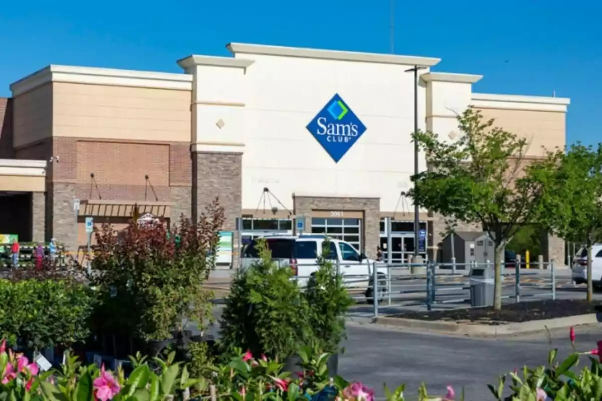 Sam's Club store facade with a parking lot in front and vegetation in the foreground. Sam's Club store facade with a parking lot in front and vegetation in the foreground.