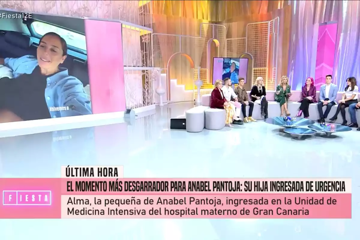 'Fiesta' muestra a un grupo de personas sentadas en un set colorido mientras en una pantalla grande se proyecta la imagen de Anabel Pantoja en un coche. En la parte inferior de la imagen, un texto informa sobre una noticia urgente relacionada con la hija de Anabel Pantoja.