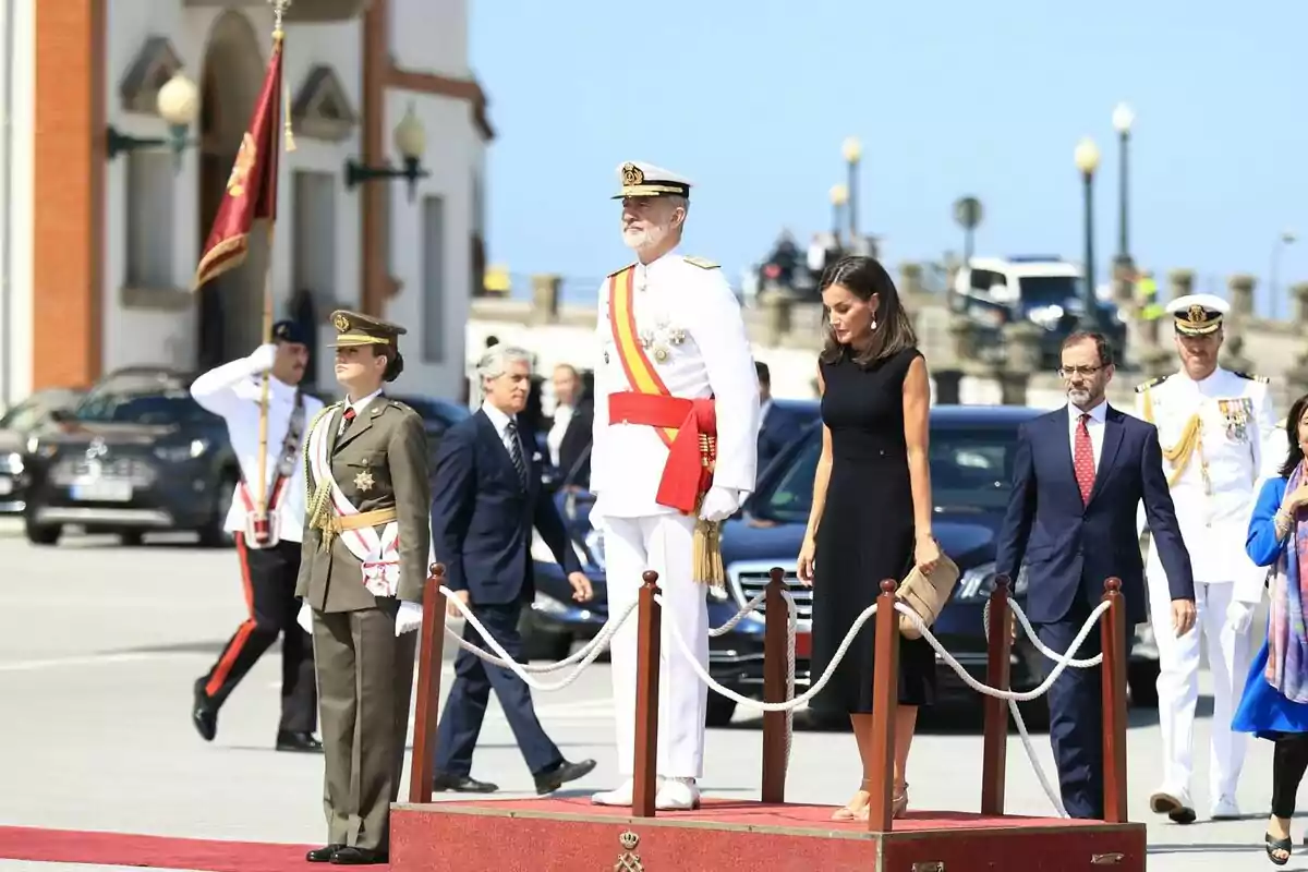 An official ceremony with several people, including military and civilians, in an outdoor setting. An official ceremony with several people, including military and civilians, in an outdoor setting.