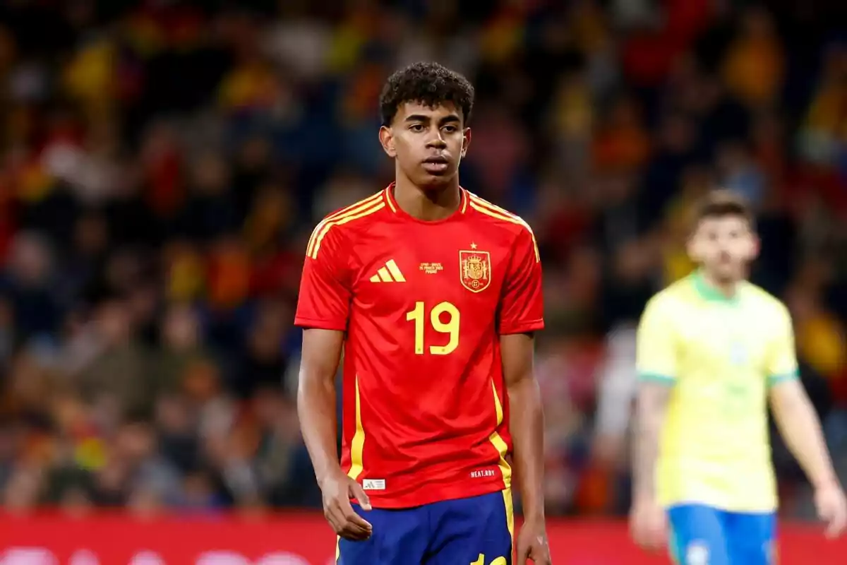 Photo of Lamine Yamal walking on the field with a serious face during a match of the Spanish National Football Team. Photo of Lamine Yamal walking on the field with a serious face during a match of the Spanish National Football Team.