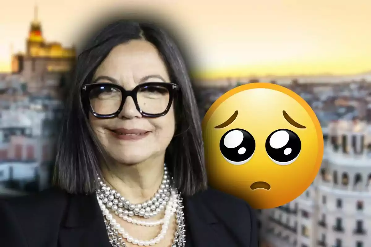Dark-haired woman with large glasses, a pearl necklace, and a sad face emoji against a blurred urban background at sunset
