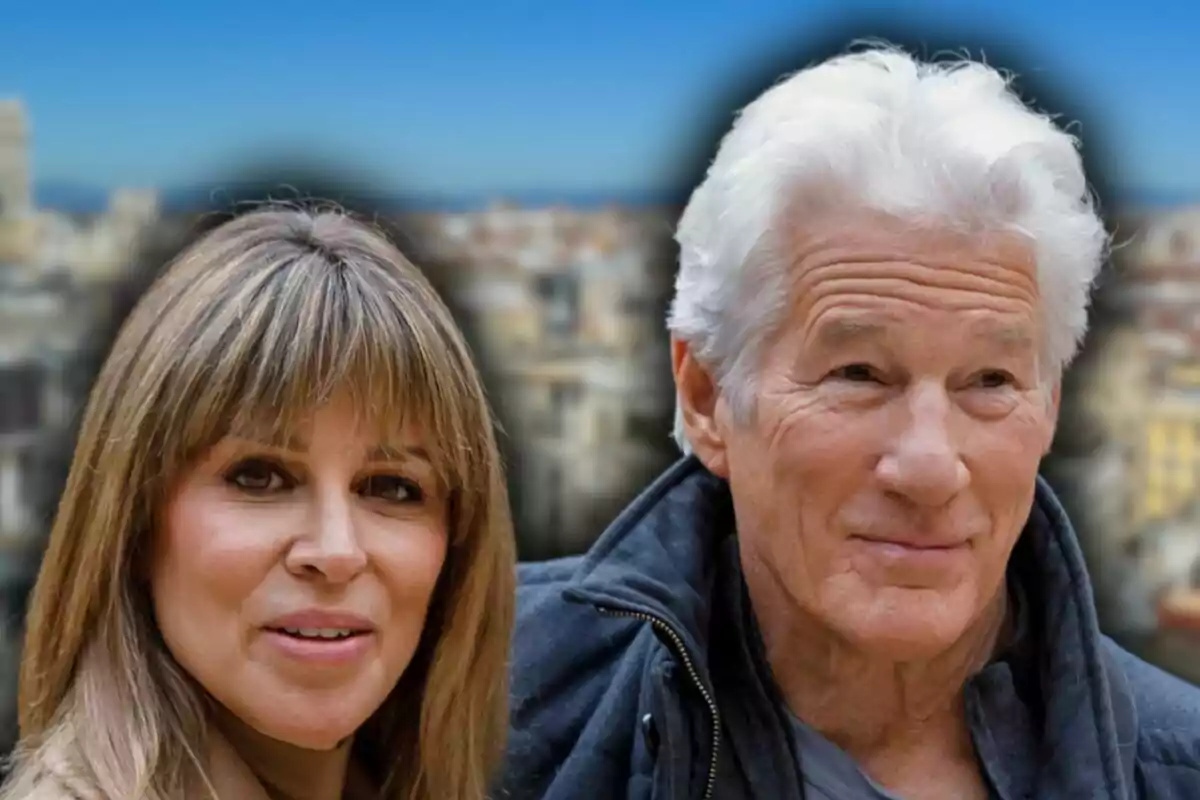 A gray-haired woman and man pose together outdoors with a blurred urban background.