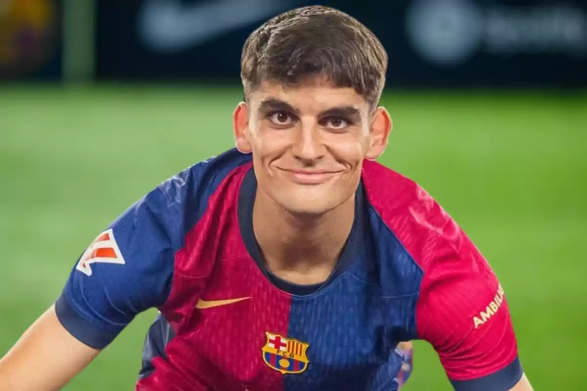 A player wearing the FC Barcelona jersey smiles while leaning forward on a playing field. A player wearing the FC Barcelona jersey smiles while leaning forward on a playing field.