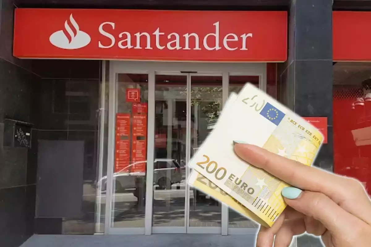 Una mà sostenint bitllets de 200 euros davant d'una sucursal del banc Santander.