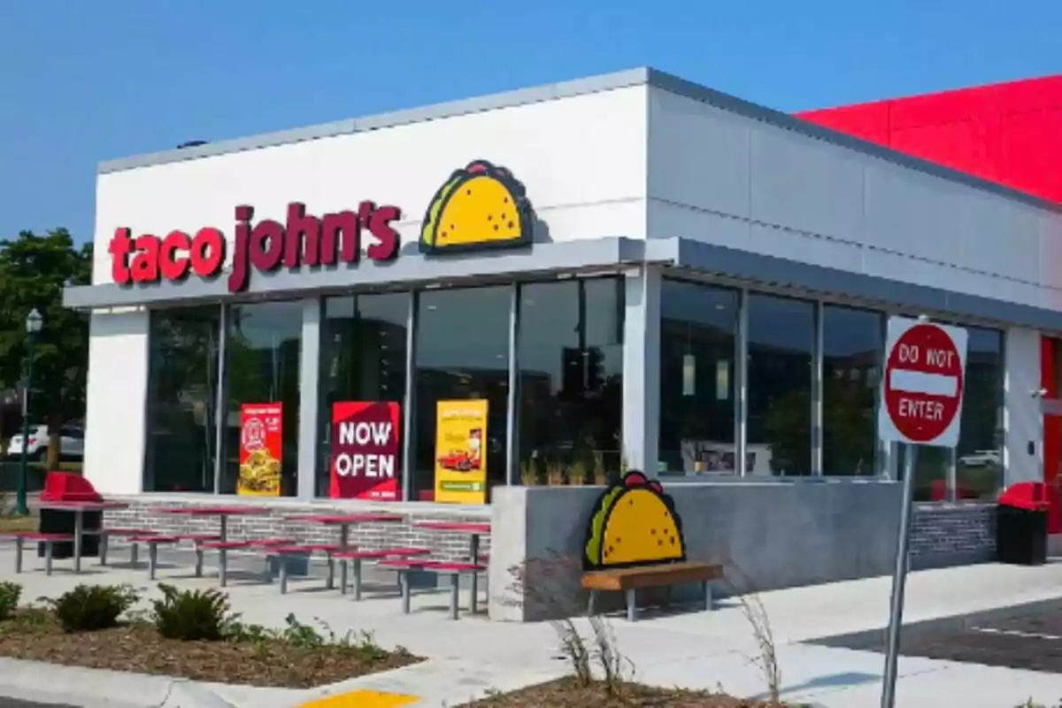 In front of a fast-food restaurant called Taco John's with a 