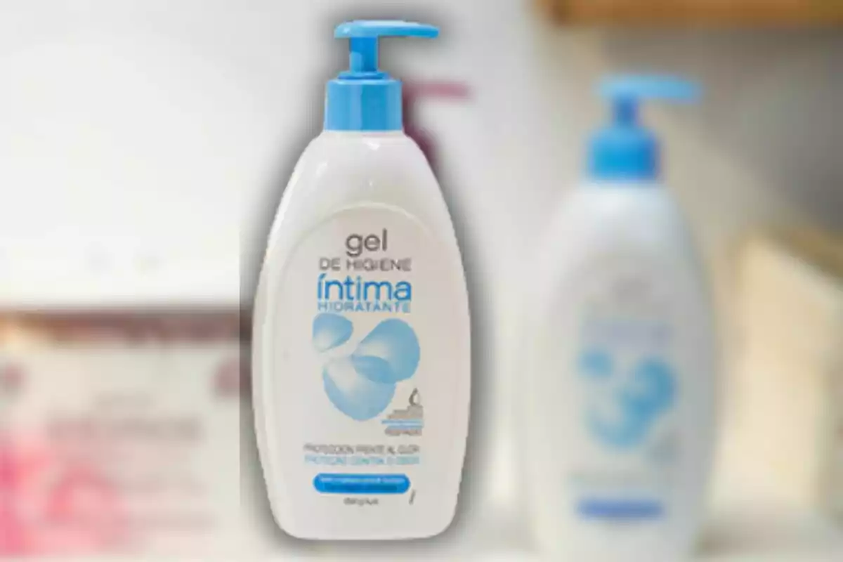 Ampolla de gel d'higiene íntima hidratant amb dispensador blau en un entorn de bany. Ampolla de gel d'higiene íntima hidratant amb dispensador blau en un entorn de bany.