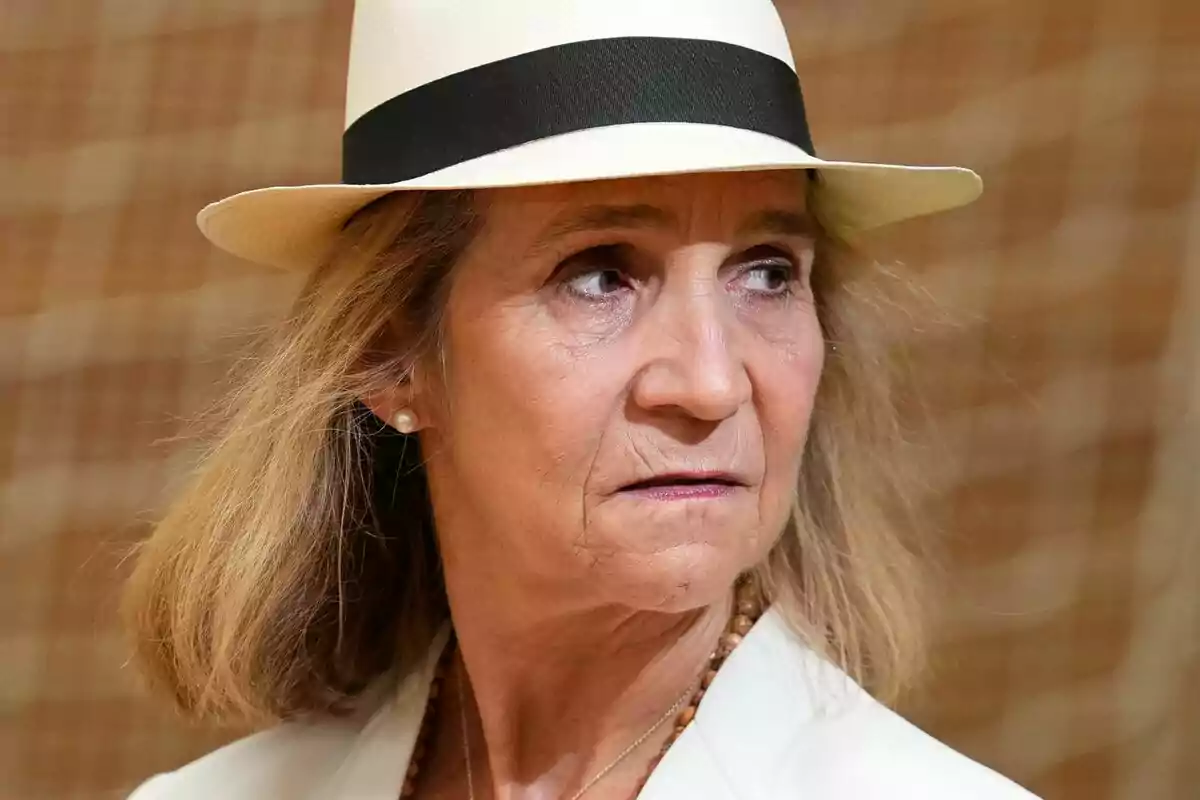 Older woman with a white hat and black ribbon looking to the side with a serious expression Older woman with a white hat and black ribbon looking to the side with a serious expression