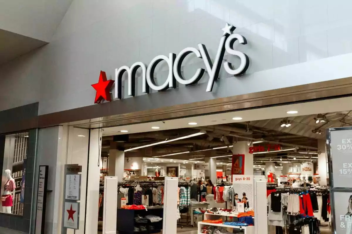 Entrance of a Macy's store with clothing displayed inside. Entrance of a Macy's store with clothing displayed inside.
