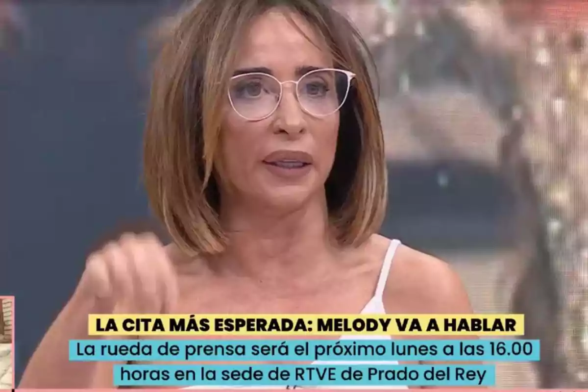 Una dona amb ulleres i cabell curt apareix en un programa de televisió amb un text a la part inferior que anuncia una roda de premsa. Una dona amb ulleres i cabell curt apareix en un programa de televisió amb un text a la part inferior que anuncia una roda de premsa.