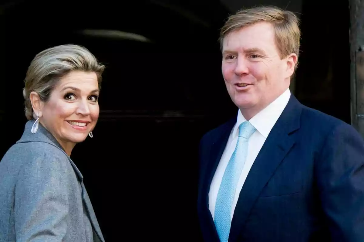 Two well-dressed people smile while looking at the camera. Two well-dressed people smile while looking at the camera.