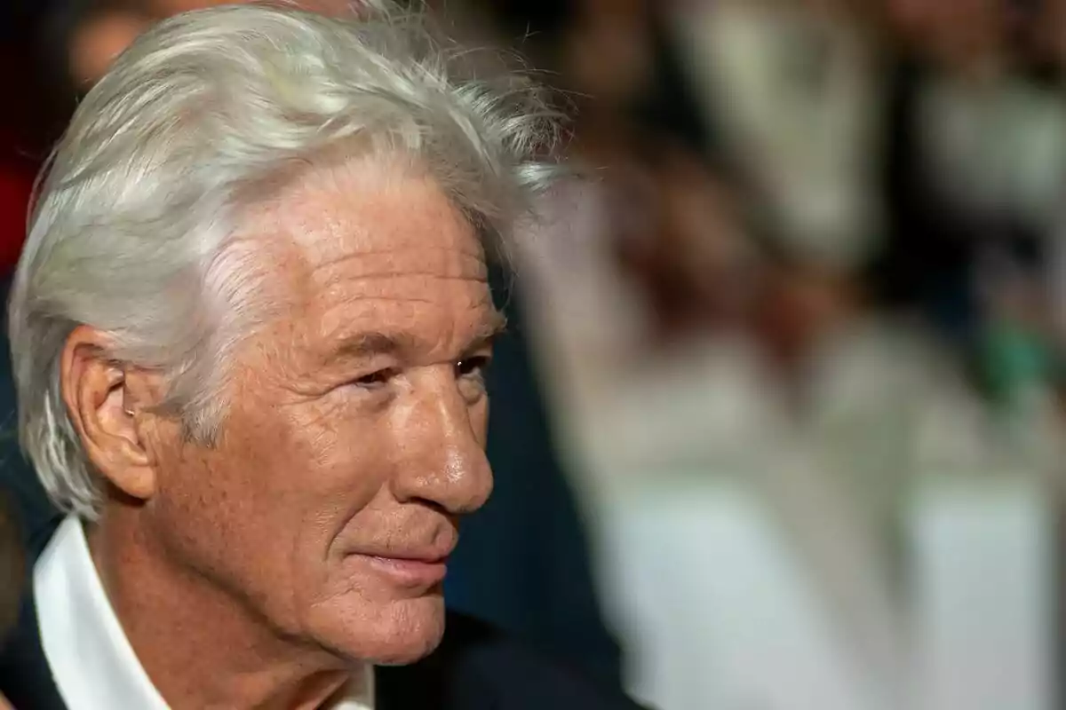Gray-haired man with a calm expression at a formal event Gray-haired man with a calm expression at a formal event