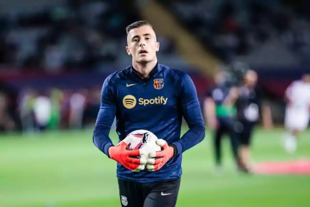 A player with red gloves holds a ball on the field. A player with red gloves holds a ball on the field.