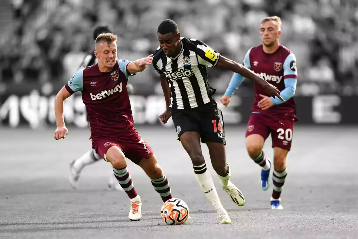 Soccer players competing for the ball in a match. Soccer players competing for the ball in a match.