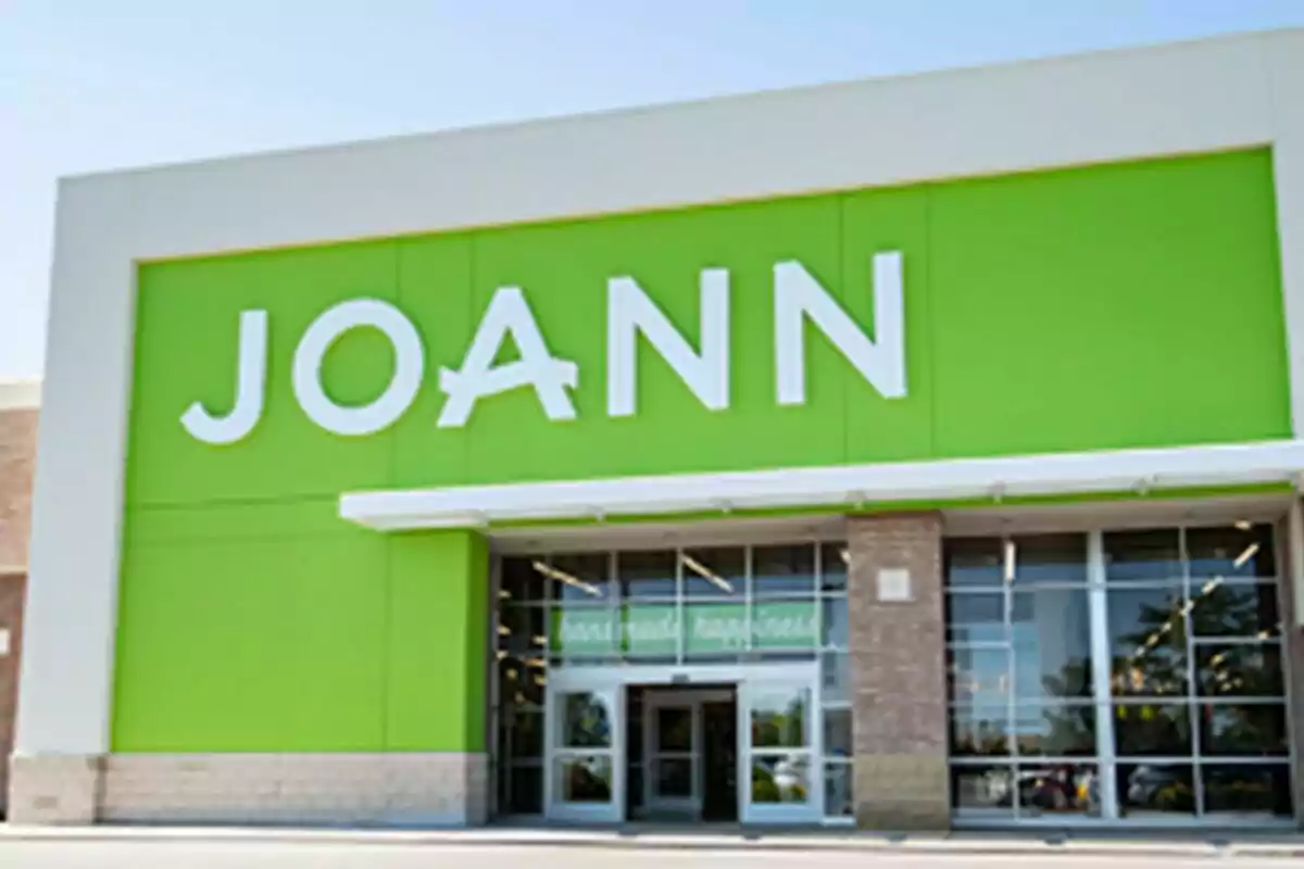 Storefront with a large sign that says JOANN on a green background. Storefront with a large sign that says JOANN on a green background.