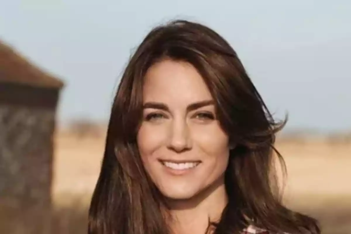 A smiling woman with dark brown hair in an outdoor setting. A smiling woman with dark brown hair in an outdoor setting.