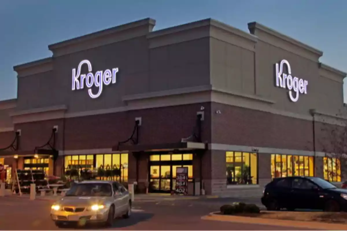 Kroger store facade at sunset with cars parked in front. Kroger store facade at sunset with cars parked in front.