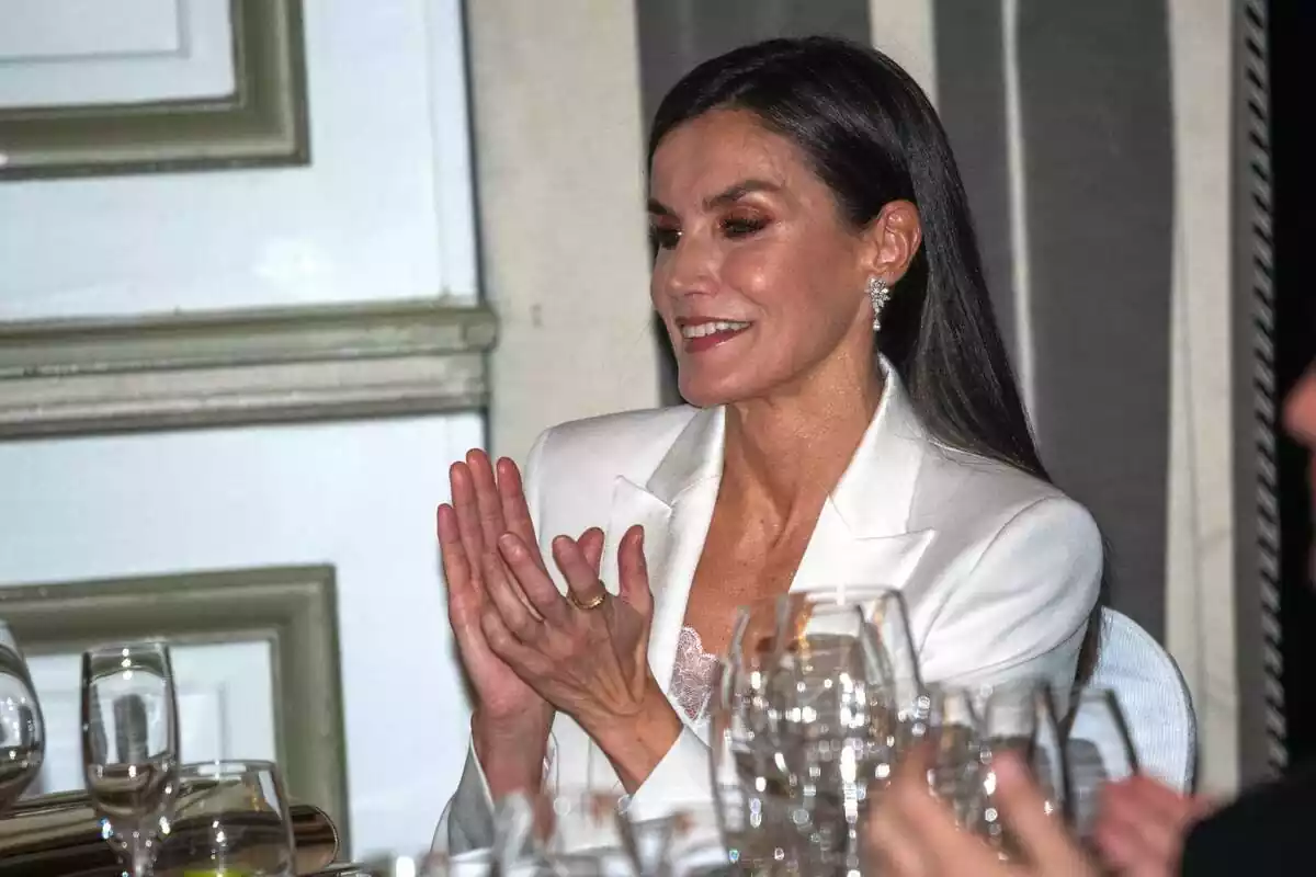 La reina Letizia amb un vestit blanc aplaudint somrient La reina Letizia amb un vestit blanc aplaudint somrient