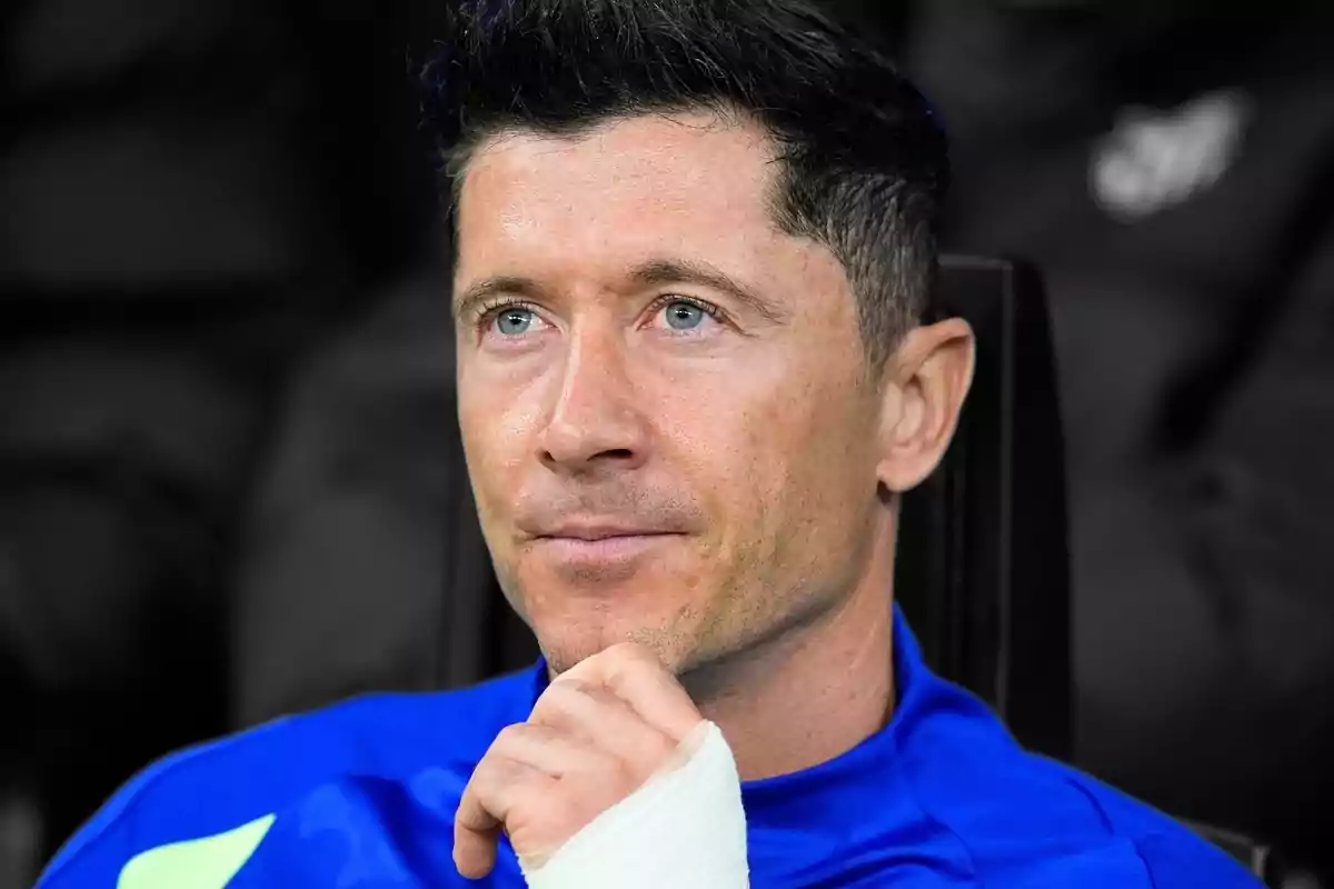 Dark-haired man with a thoughtful expression wearing a blue t-jersey and a white bandage on his hand Dark-haired man with a thoughtful expression wearing a blue t-jersey and a white bandage on his hand