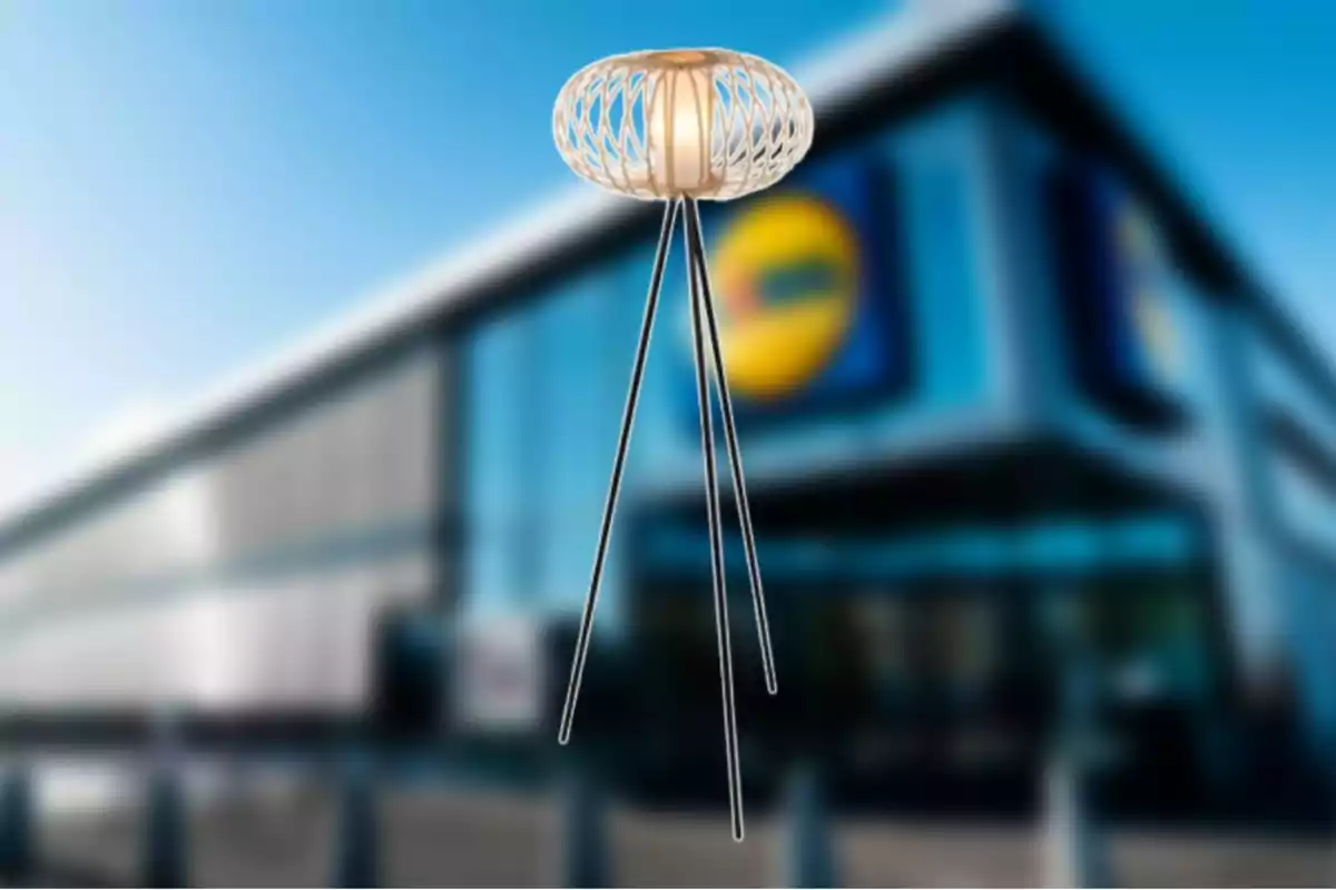 Una làmpada de disseny modern amb estructura de metall i pantalla teixida es troba davant d'un edifici borros. Una làmpada de disseny modern amb estructura de metall i pantalla teixida es troba davant d'un edifici borros.