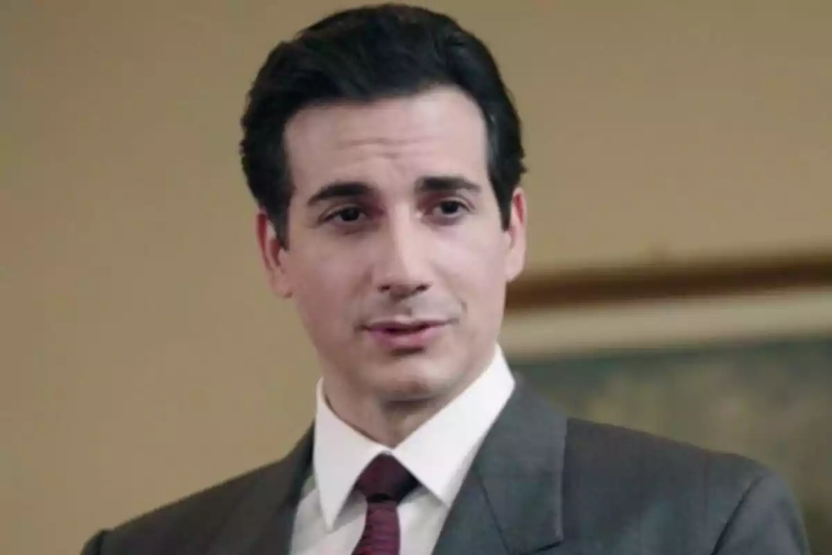 Luca Bastianello in a dark suit and red tie looks forward with a serious expression. Luca Bastianello in a dark suit and red tie looks forward with a serious expression.