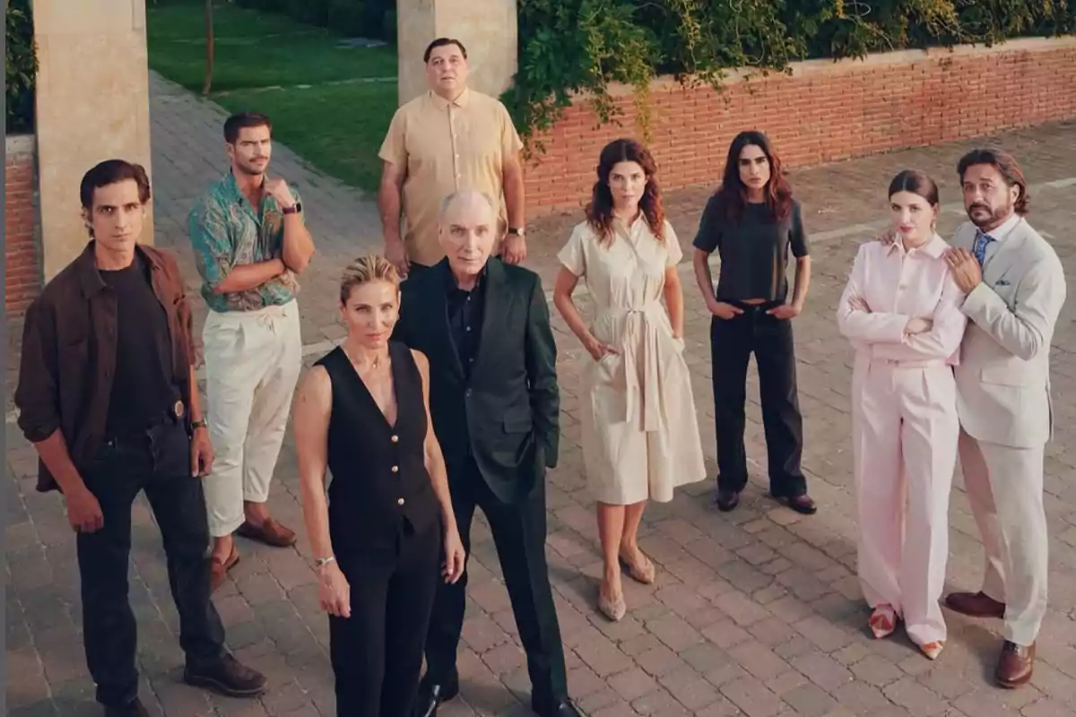 A group of people posing outdoors in an urban setting with vegetation in the background. A group of people posing outdoors in an urban setting with vegetation in the background.