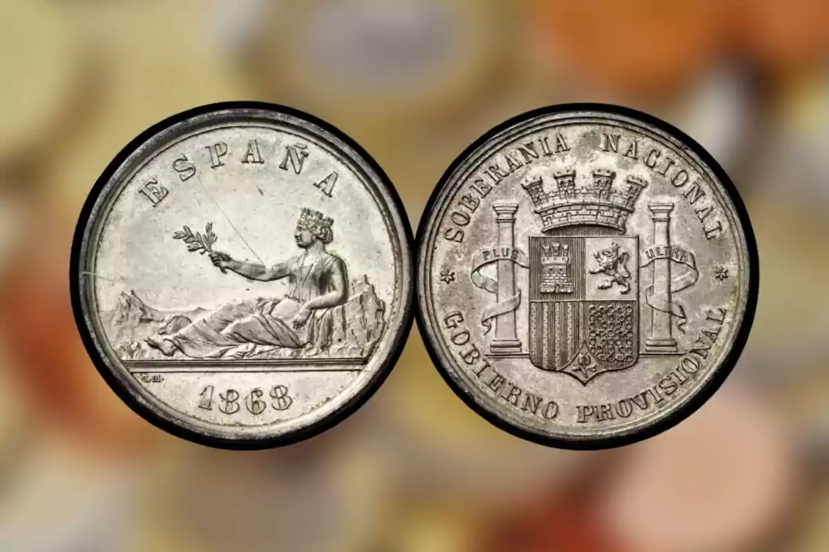 Moneda antiga d'Espanya de 1868 amb una figura femenina asseguda sostenint una branca en un costat i un escut amb la inscripció Moneda antiga d'Espanya de 1868 amb una figura femenina asseguda sostenint una branca en un costat i un escut amb la inscripció