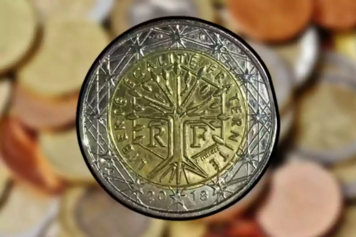 Moneda de dos euros amb disseny francès i fons d'altres monedes desenfocades. Moneda de dos euros amb disseny francès i fons d'altres monedes desenfocades.