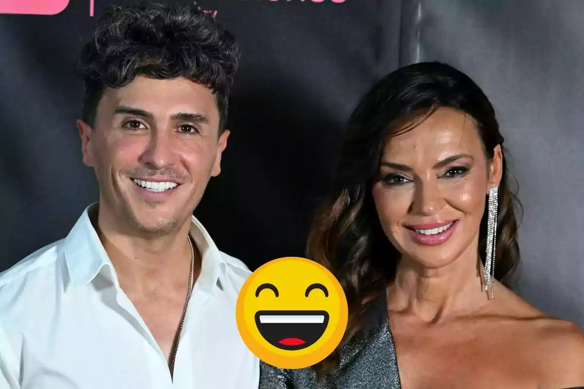 Agustín Etienne and Olga Moreno, smiling, pose in front of a dark background, and a happy face emoji partially covers the image.