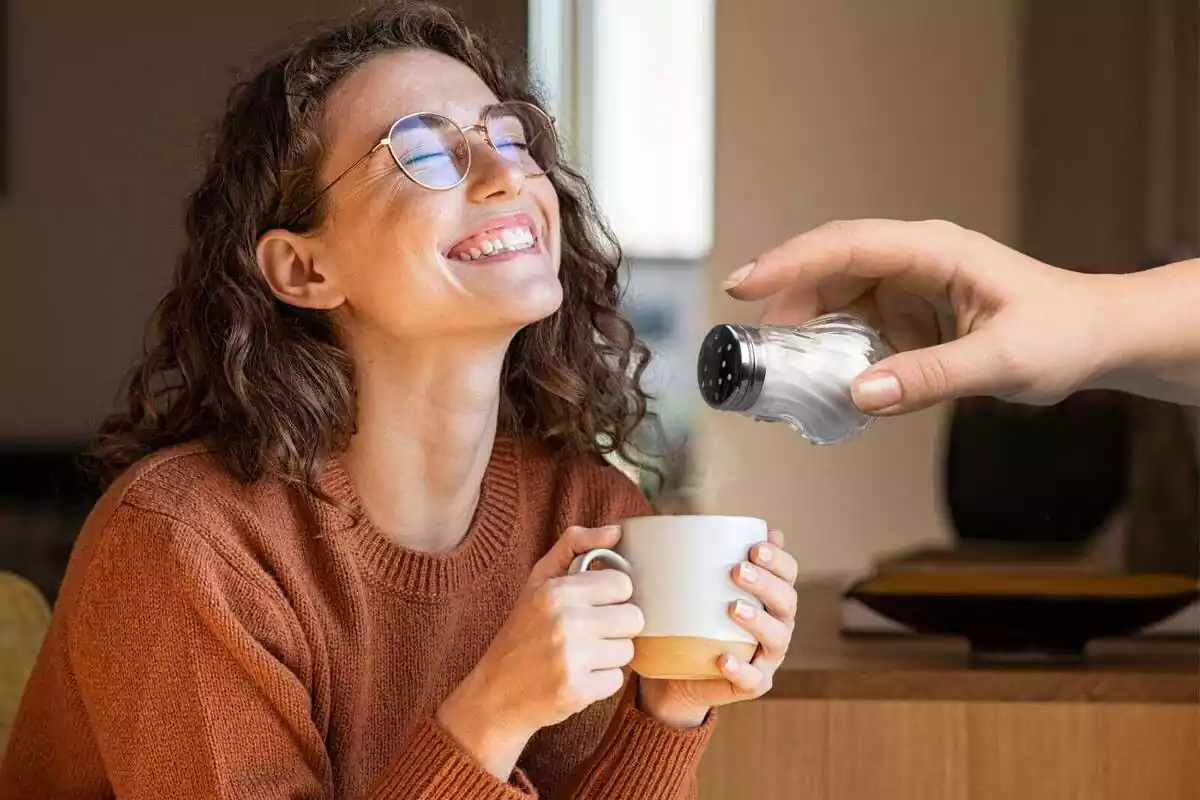 Montage of a smiling girl drinking coffee and a hand making salt Montage of a smiling girl drinking coffee and a hand making salt