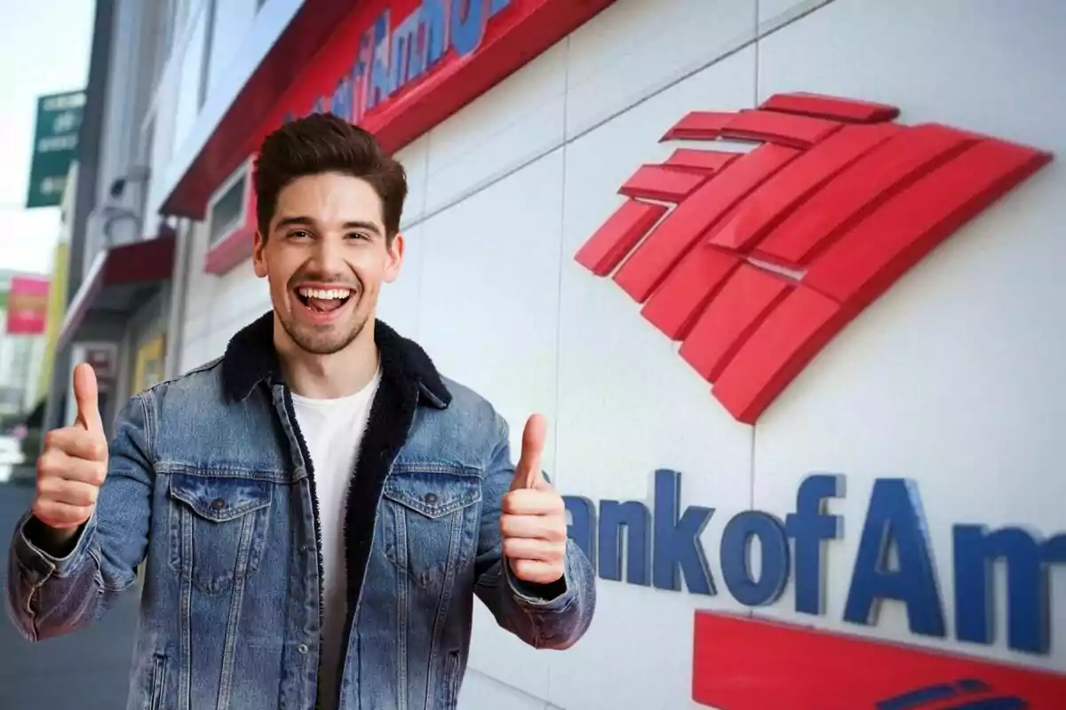 A smiling man in a denim jacket gives a thumbs-up in front of a building with a bank logo. A smiling man in a denim jacket gives a thumbs-up in front of a building with a bank logo.