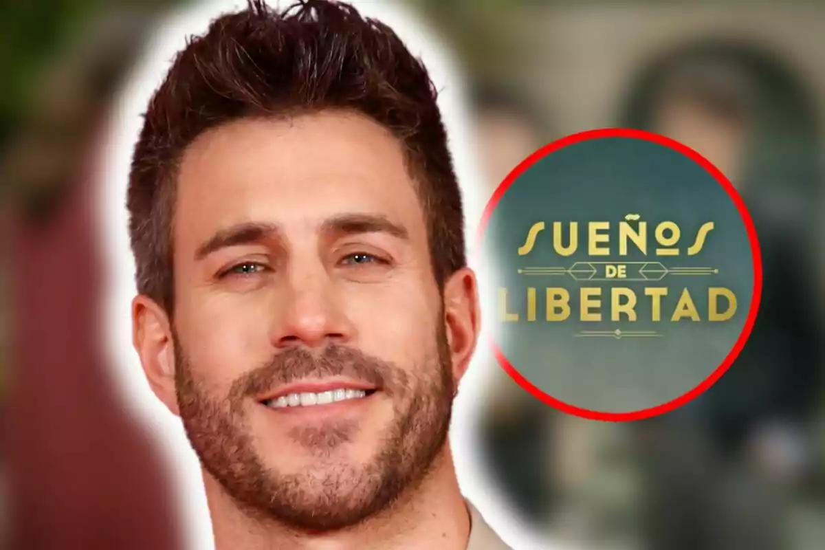 Primer pla de Dani Tatay amb barba davant d'un cartell que diu "Sueños de Libertad".