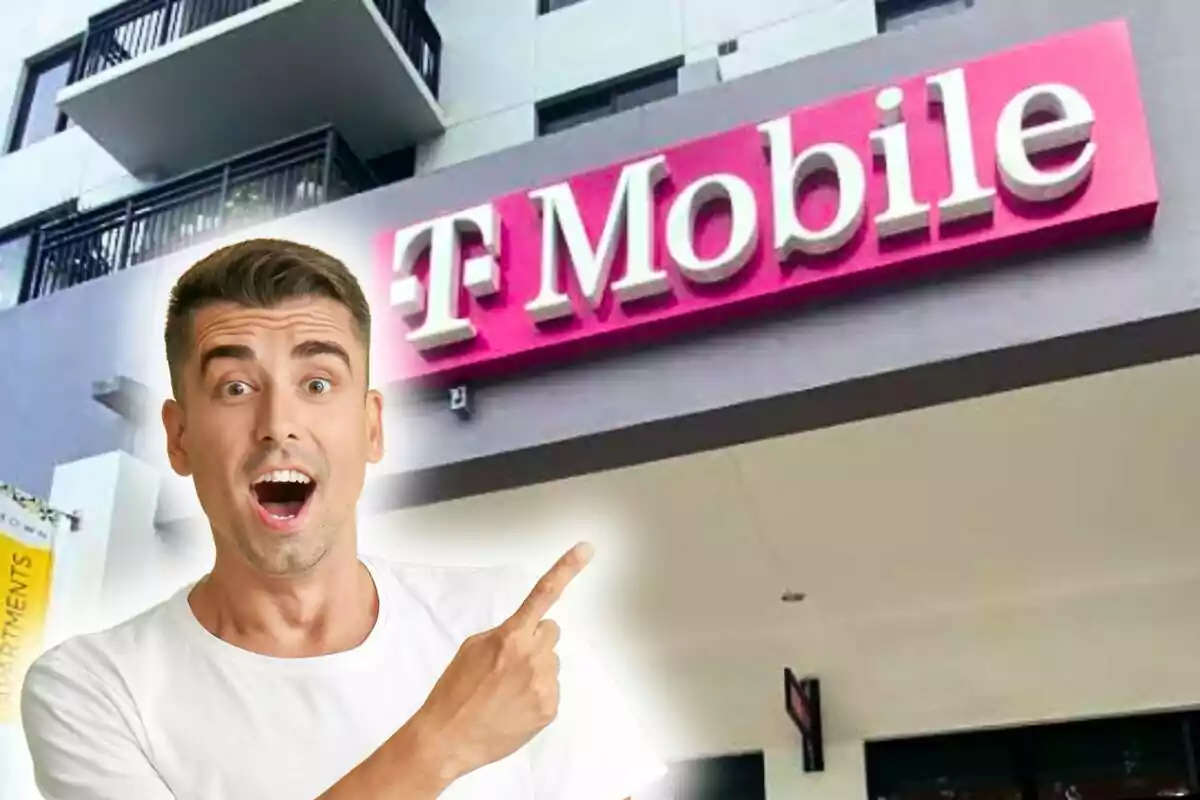 Man surprised pointing at a T-Mobile sign on a building.