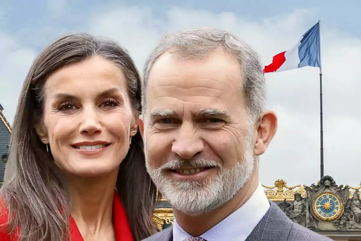 Felipe VI and Letizia Ortiz pose in front of a building with a French flag waving in the background.